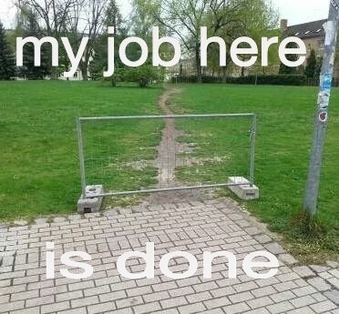 A fence in front of a well-trodden path.